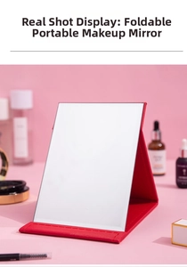 Detailed view of a portable folding makeup mirror with red leather stand