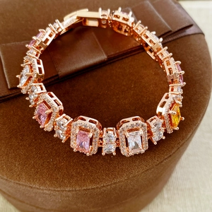 Macro view of rose gold bracelet with colorful cubic zirconia in a velvet gift box