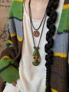 Detailed macro view of Bohemian ethnic teardrop necklace with tassel decoration