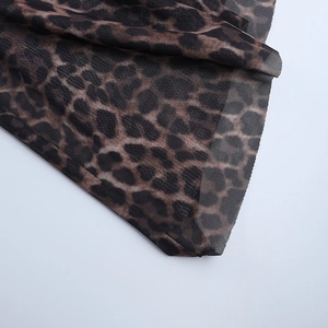 Close-up of leopard print mesh fabric showing sheer texture and drape for summer dresses