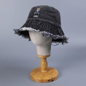 Distressed grey washed denim bucket hat with frayed edges and bear embroidery motif