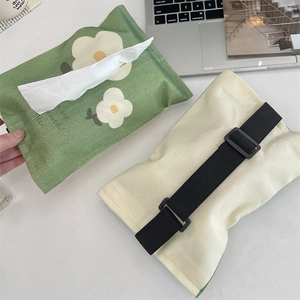 Detail of green linen car tissue holder featuring daisy print and adjustable buckle strap