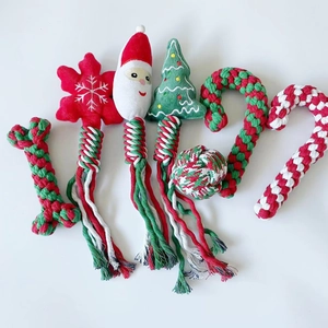 Detail of Christmas dog toy set with woven cotton bone and tree shapes on white background