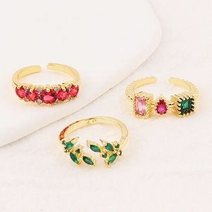 Detailed view of adjustable gold-plated rings featuring colorful zircon gemstones
