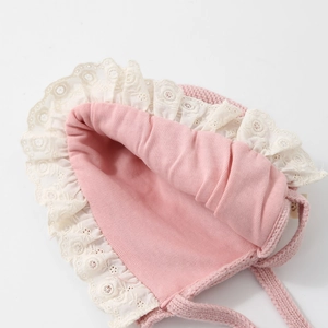 Pink knit baby girl bonnet with white lace trim and cotton lining for autumn and winter