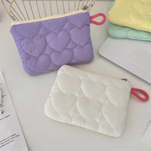 Detailed top view of quilted heart-pattern nylon mini storage bags in candy colors