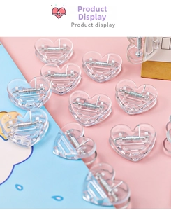 Mini transparent heart-shaped plastic clips scattered on a colorful pastel background