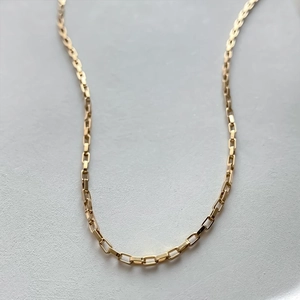 Detailed close-up showing the smooth texture of a 14K gold plated box chain necklace