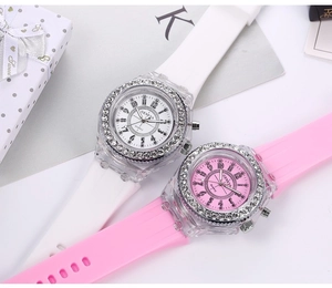 Close-up of pink and white Geneva quartz watches with rhinestone bezels and silicone bands
