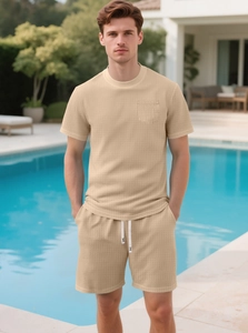 Close-up of beige waffle knit texture on men's summer short set by an outdoor pool