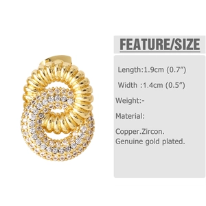 Macro detail of gold plated double hoop earrings featuring zircon stones and spiral texture