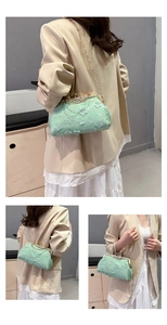 Detail view of mint green lace shell bag with pearl beads and golden chain strap