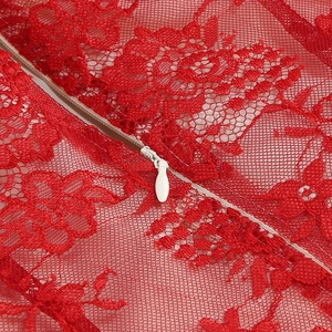 Detailed close-up of red floral lace fabric with a high-quality white invisible zipper