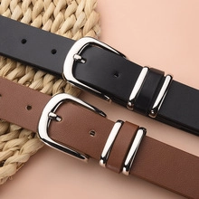 Detail of classic black and brown PU leather belts with silver metal pin buckles