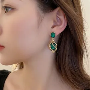 Elegant emerald green and gold teardrop earrings for women in a vintage luxury style