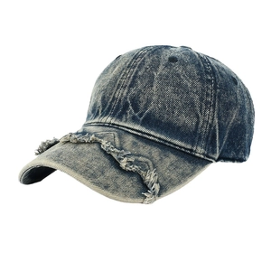 Vintage washed navy blue denim baseball cap with distressed brim and frayed edges