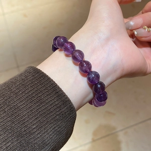 Close-up of natural purple amethyst beaded bracelet on wrist with 8mm-10mm round gems
