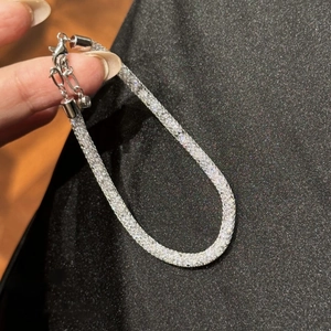 Close-up of sparkling silver bracelet with pavé rhinestones and lobster clasp closure