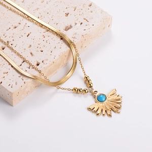 Vintage gold layered necklace with sun pendant and blue turquoise stone on stone base