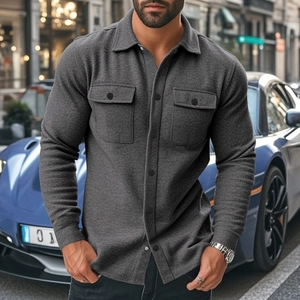 Detail shot of grey flannel shirt jacket showing durable fabric texture and double chest pockets