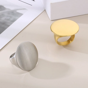 Detail of round flat surface minimalist rings in polished gold and silver finishes