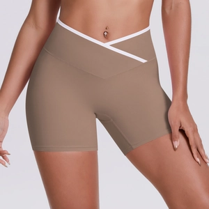 Detail of cross high-waist yoga shorts with V-shaped white trim on khaki fabric