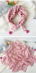 Detail of pink cotton linen square scarf featuring peach prints and fuchsia corner tassels