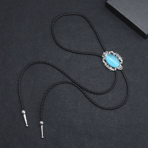 Vintage bolo tie with blue faux cat-eye stone and silver-tone western pendant on black cord