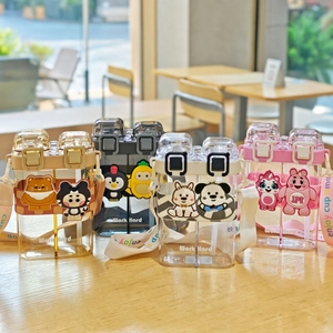 Detail of dual-sip plastic water bottles with colorful cartoon silicone sleeves and straps