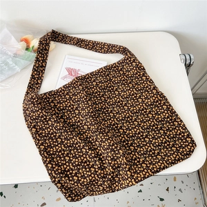 Detail of floral corduroy tote bag showing soft ribbed texture and vintage floral pattern