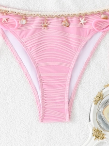 Pink ribbed bikini bottoms featuring decorative sea shells and starfishes with side ties