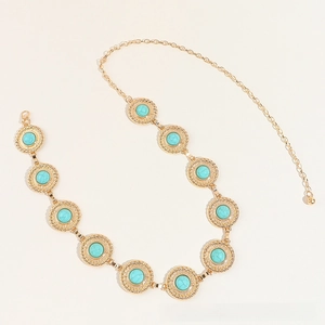 Detail of gold chain belt featuring turquoise marble stone inlays and lobster clasp