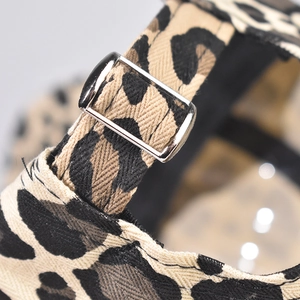 Detailed close-up of leopard print baseball cap with adjustable silver metal buckle