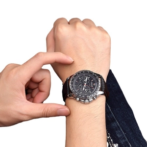 Megir men's chronograph sports watch with brown leather strap and black dial on wrist