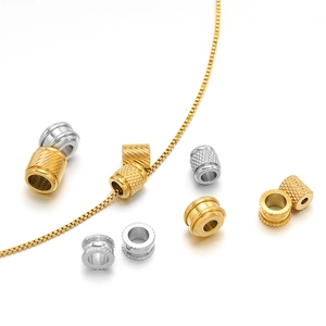 Gold and silver stainless steel textured beads displayed on a chain for DIY jewelry
