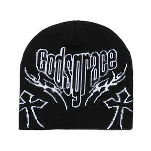 Macro detail of Godsgrace letters and cross totem on black knitted beanie hat