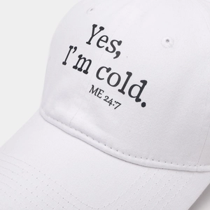 Close-up of vintage washed white baseball cap with black letter print and cotton texture