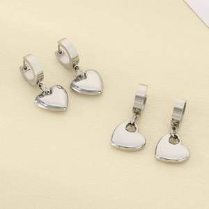 Detailed view of silver heart-shaped hoop earrings in solid and hollowed out designs