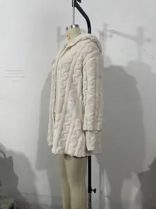 Detail view of cream hooded cardigan featuring textured diamond pattern and ribbed cuffs