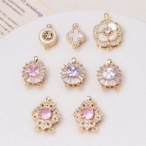 Macro detail of gold-plated flower and swan clasps with zircon for DIY jewelry making