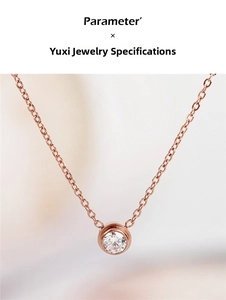 Detailed view of rose gold bezel-set solitaire diamond pendant with fine cross chain