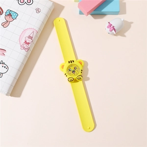 Macro detail of yellow silicone snap watch with cute cartoon tiger face for children