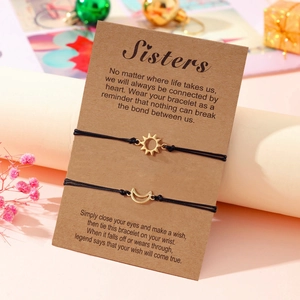 Detail of adjustable sun and moon charm bracelets on Sisters message card packaging