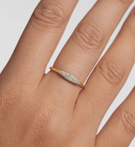 Close-up of minimalist gold-plated ring with shimmering olive-shaped pavé zirconias
