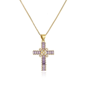 Gold plated cross necklace with purple baguette gems and white zircon on white background