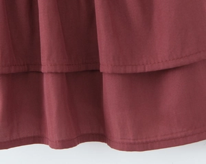 Close-up of dark red layered ruffle hem showing detailed cotton linen fabric texture