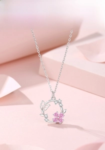 Macro shot of S925 silver necklace with pink heart zircon flowers and butterfly pendant