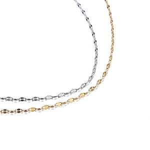 Close-up of flat link chains in polished gold and silver stainless steel finishes