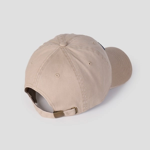 Detail view of khaki baseball cap featuring adjustable bronze metal buckle and cotton strap
