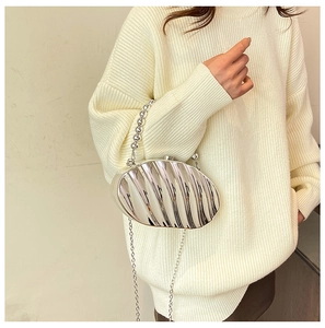Silver shell-shaped acrylic evening bag with pearl handle and metal chain shoulder strap